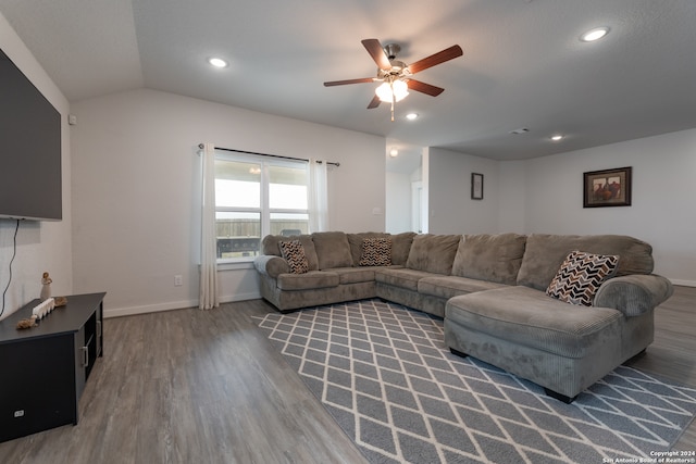 living room with wood-type flooring, lofted ceiling, and ceiling fan