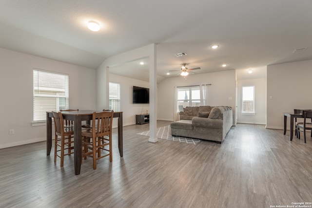 dining space featuring vaulted ceiling, hardwood / wood-style floors, and ceiling fan