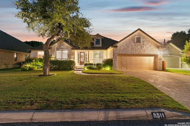 view of front of property featuring a yard and a garage