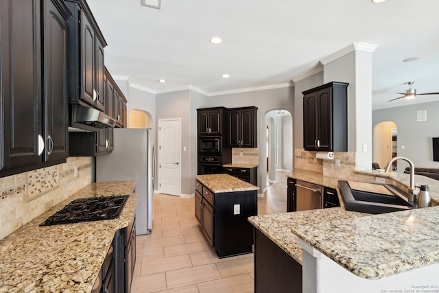 kitchen featuring kitchen peninsula, a kitchen island, black appliances, ceiling fan, and sink