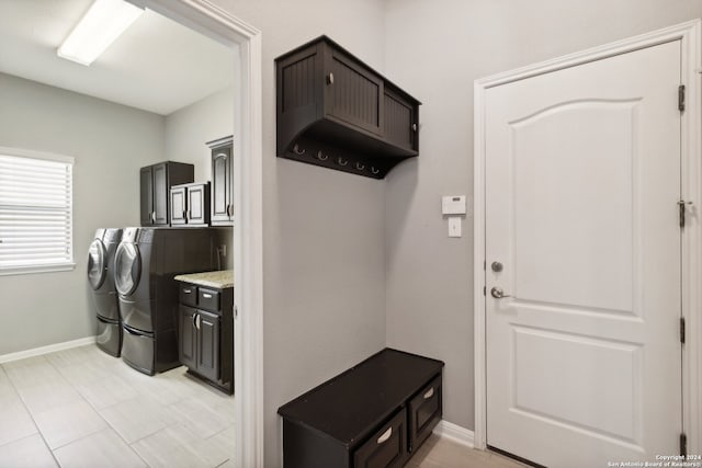 mudroom featuring washing machine and clothes dryer and light tile patterned floors