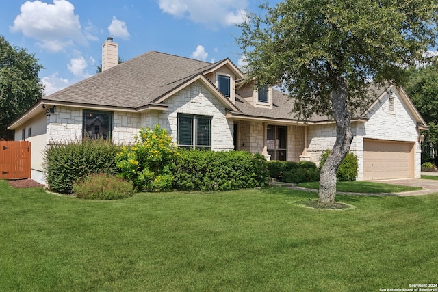 view of front of property with a front lawn and a garage