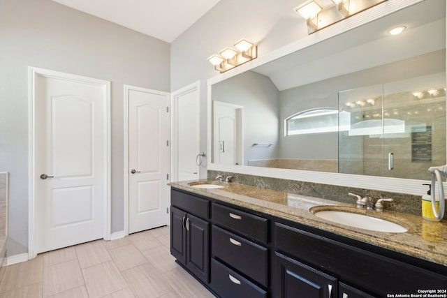 bathroom with tile patterned flooring, lofted ceiling, an enclosed shower, and vanity