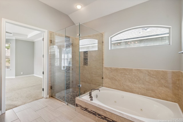 bathroom featuring tile patterned flooring, lofted ceiling, and independent shower and bath