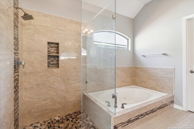 bathroom with lofted ceiling, independent shower and bath, and tile patterned floors