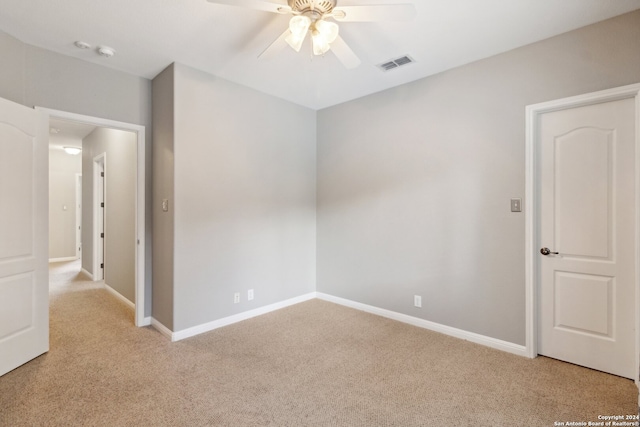 carpeted spare room featuring ceiling fan