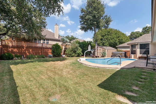 view of pool with a storage unit, a water slide, and a yard