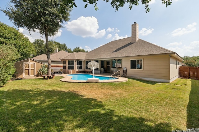 rear view of property with a storage shed, a patio, and a yard