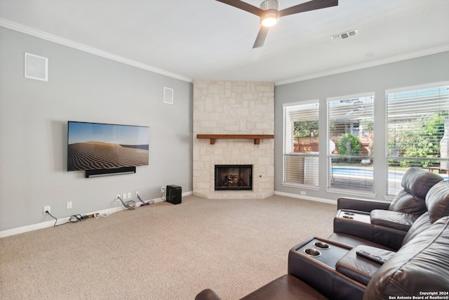 carpeted living room with crown molding, a fireplace, and ceiling fan