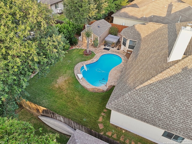 view of swimming pool with a yard, a patio area, and an outbuilding