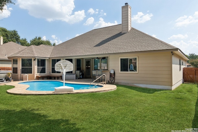 view of swimming pool featuring a patio area and a yard