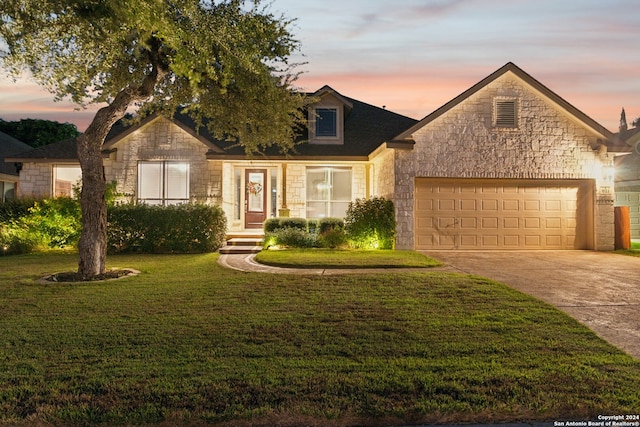 view of front of property with a yard and a garage