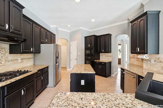 kitchen featuring decorative backsplash, exhaust hood, black appliances, crown molding, and a center island