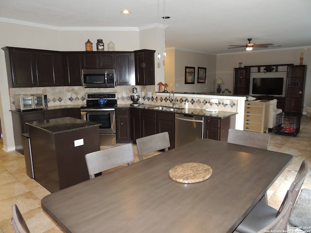 dining area with light tile patterned flooring, ornamental molding, sink, and ceiling fan