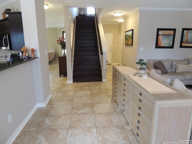 interior space featuring ornamental molding and light tile patterned floors