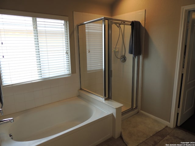 bathroom featuring separate shower and tub