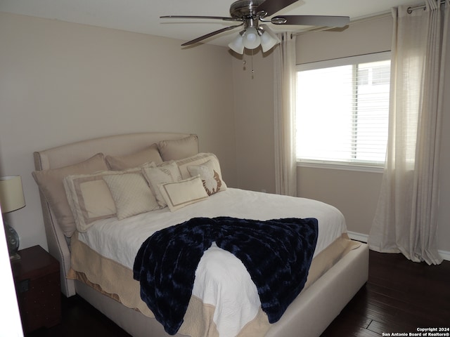 bedroom featuring dark wood-type flooring and ceiling fan