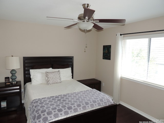 bedroom with ceiling fan and dark wood-type flooring