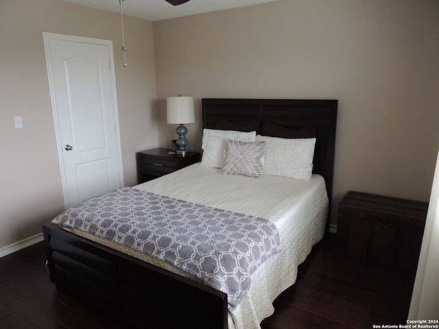 bedroom with dark hardwood / wood-style flooring