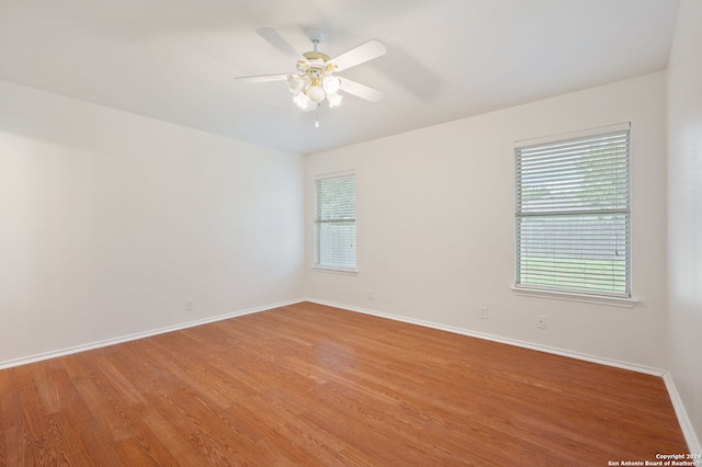 unfurnished room with ceiling fan and hardwood / wood-style flooring