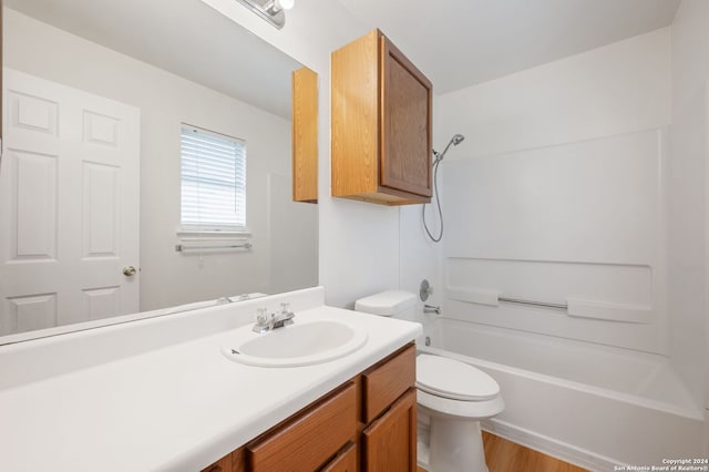 full bathroom featuring washtub / shower combination, vanity, toilet, and hardwood / wood-style floors