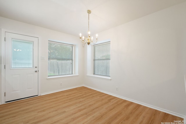 interior space featuring a notable chandelier and light wood-type flooring