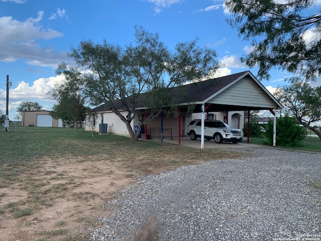 view of parking / parking lot with a lawn and a carport