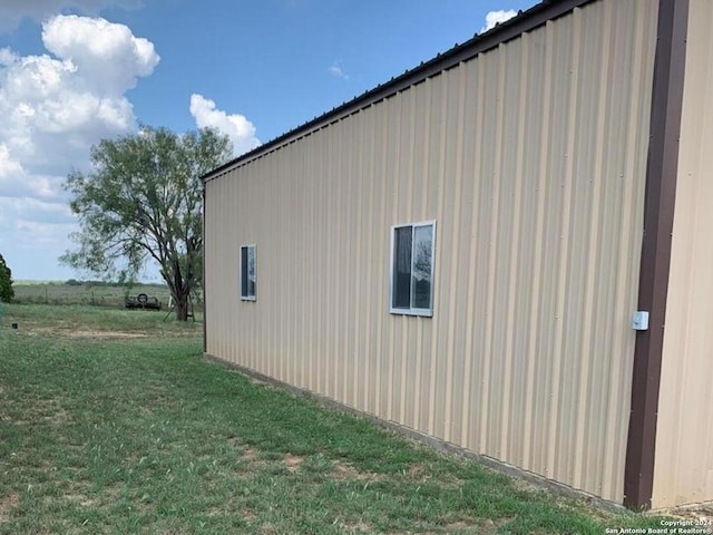 view of home's exterior with a yard