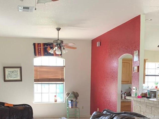 interior space featuring ceiling fan and a healthy amount of sunlight