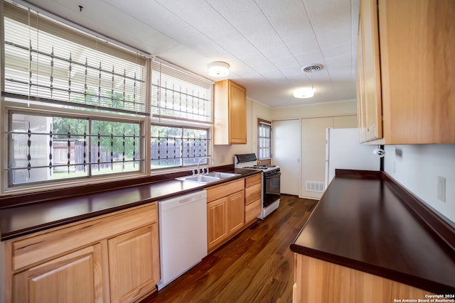 kitchen with dark hardwood / wood-style flooring, light brown cabinets, sink, and white appliances