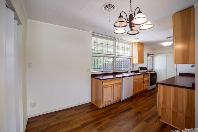 kitchen with white appliances, dark hardwood / wood-style flooring, decorative light fixtures, sink, and a notable chandelier