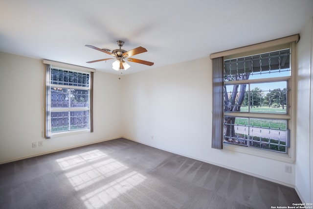 spare room featuring ceiling fan and carpet floors