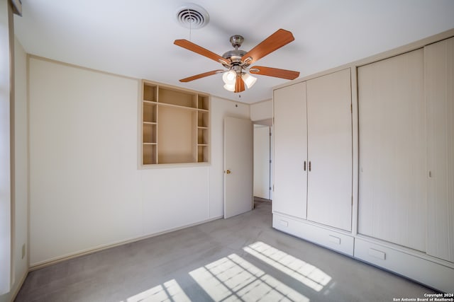 unfurnished bedroom featuring two closets and ceiling fan