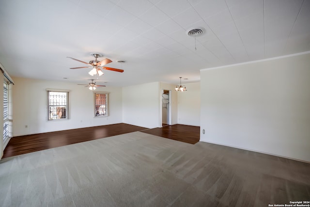 unfurnished room with ceiling fan with notable chandelier, crown molding, and dark hardwood / wood-style flooring