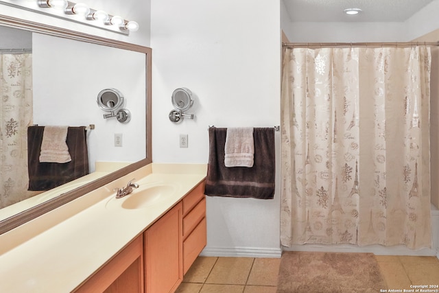 bathroom with shower / bath combo, tile patterned flooring, and vanity