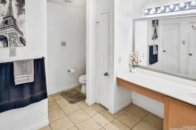 bathroom with vanity, tile patterned flooring, and toilet