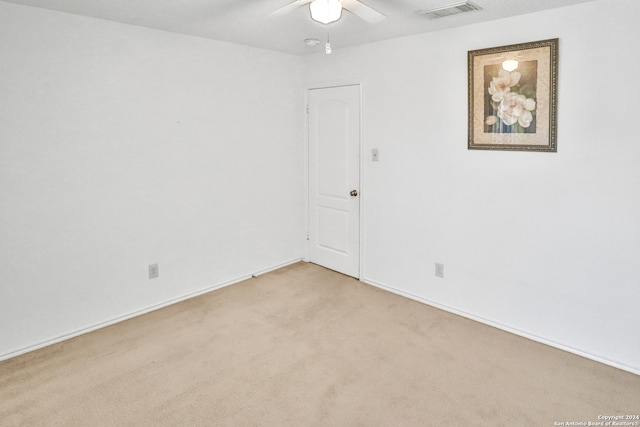 empty room with light carpet and ceiling fan