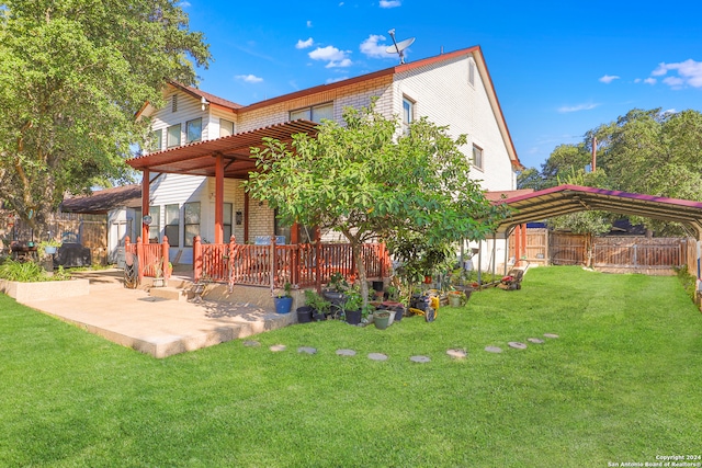 rear view of house with a lawn and a patio