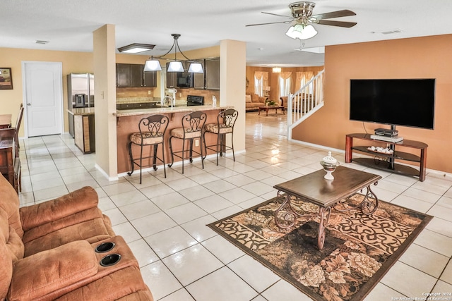 tiled living room with ceiling fan