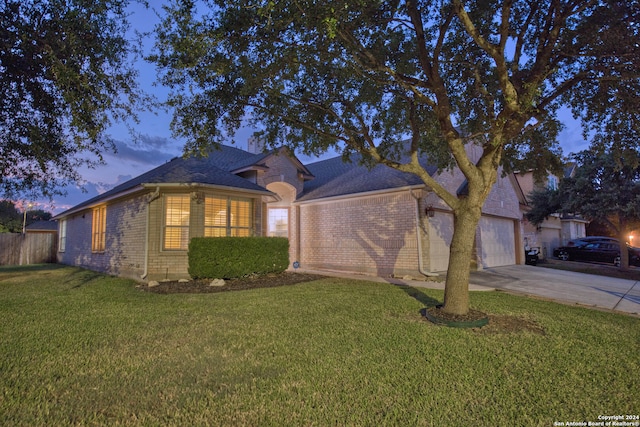 ranch-style house with a yard and a garage