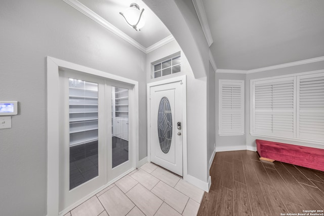 entryway featuring light hardwood / wood-style floors and ornamental molding