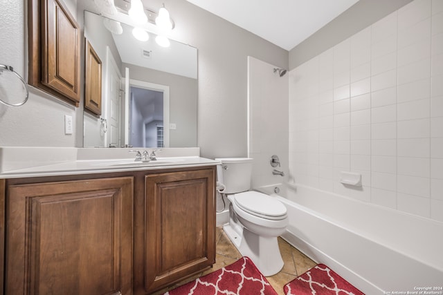 full bathroom featuring vanity, tile patterned flooring, toilet, and tiled shower / bath