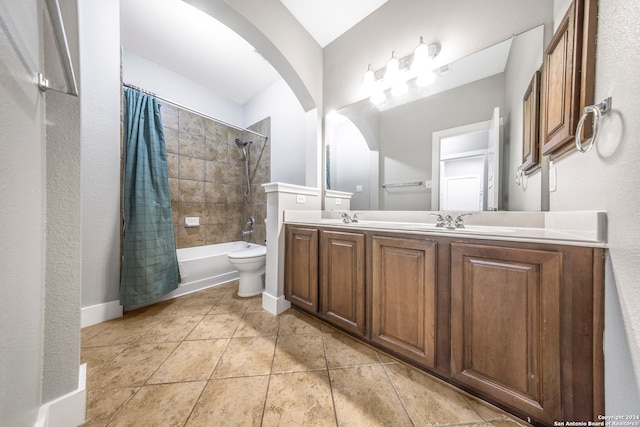 full bathroom featuring tile patterned flooring, shower / bath combo, vanity, and toilet