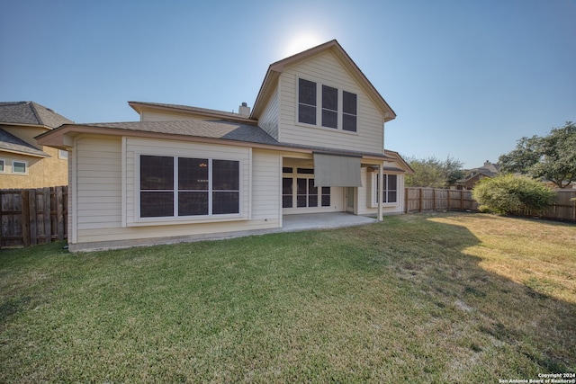 rear view of property featuring a patio area and a lawn