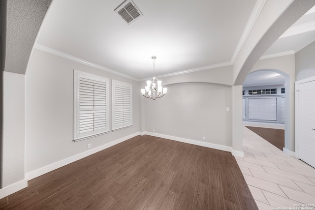 unfurnished dining area featuring a notable chandelier, ornamental molding, and hardwood / wood-style flooring