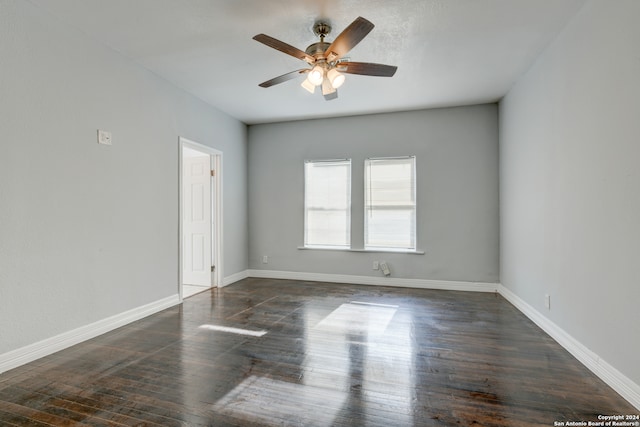 spare room featuring dark hardwood / wood-style flooring and ceiling fan