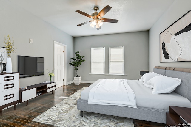 bedroom with dark hardwood / wood-style floors and ceiling fan