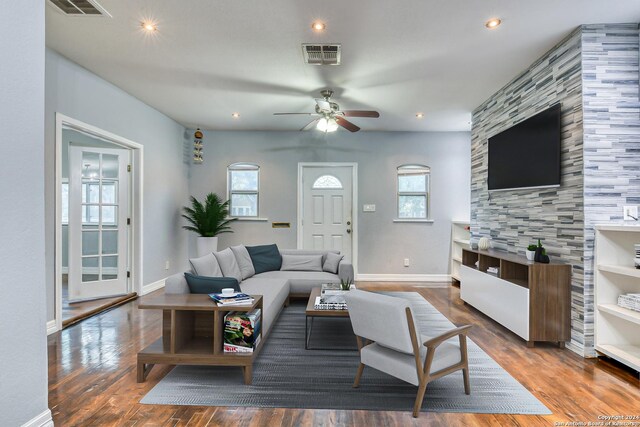 living room featuring dark hardwood / wood-style flooring and ceiling fan