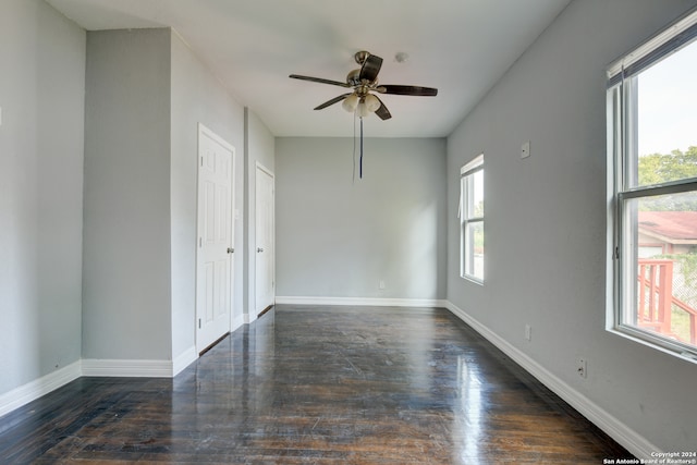 spare room with ceiling fan, dark hardwood / wood-style floors, and a healthy amount of sunlight