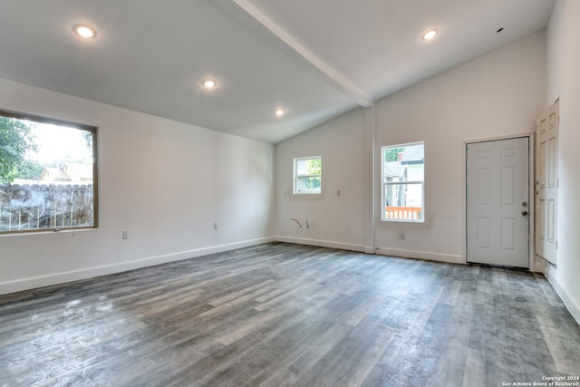 empty room with beam ceiling, high vaulted ceiling, and hardwood / wood-style flooring